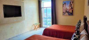 Postel nebo postele na pokoji v ubytování Hotel Camino de Piedra