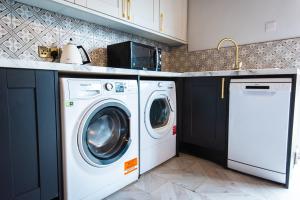 a white washer and dryer in a kitchen at Sallow Tree House Self Catering in Selby