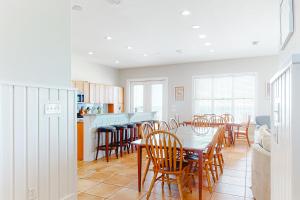 a kitchen and dining room with a table and chairs at Lund - Nordic Villas in Orange Beach