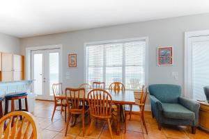 a kitchen and dining room with a table and chairs at Lund - Nordic Villas in Orange Beach