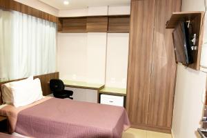 a hotel room with a bed and a tv at Lis Hotel in Teresina