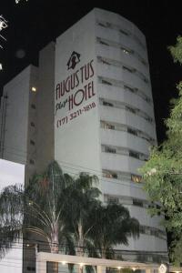 a building with a sign on the side of it at Augustus Plaza Hotel in Sao Jose do Rio Preto