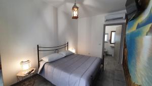 a bedroom with a large bed and a bathroom at Fly Bed - Milano Malpensa Airport in Cardano al Campo +1 photo