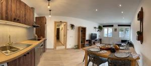 a kitchen with a sink and a table in a room at Casa Joana - Apartamento La Colomina- se admiten mascotas in Bernúy +26 photos
