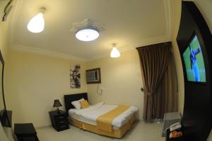 Ліжко або ліжка в номері Hona Al Holm Furnished Units