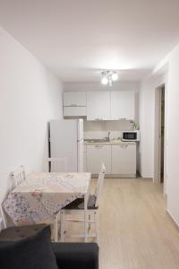 a white kitchen with a table and chairs in a room at B&B da Mamma Anna in Matera