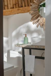 a bathroom with a sink and a mirror on a table at El Valle Lodge in El Valle