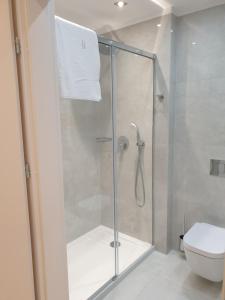 a bathroom with a glass shower with a toilet at Apartment SEA VIEW Ustronie Morskie in Ustronie Morskie