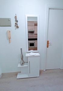 a white kitchen with a counter and a refrigerator at Apartamento El Príncipe in Peñíscola