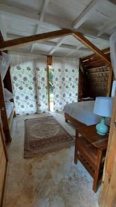 a bedroom with a bed and a table with a lamp at El Valle Lodge in El Valle