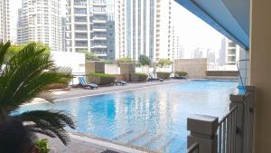 a swimming pool in a building with tall buildings at Lovely 1 Bedroom Apartment, Near Dubai Mall & Burj Khalifa, Downtown Dubai in Dubai