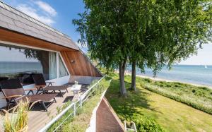 a beach house with a view of the ocean at Dream BIg Strandsuite in Rettin