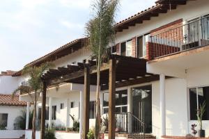 a house with palm trees in front of it at Viñas del Castillo in Ensenada