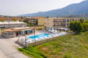 a villa with a swimming pool and a building at Pothos Hotel Alykes in Alykes