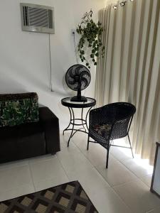 a living room with a couch and a table and chairs at Apartamento em Caldas Novas in Caldas Novas