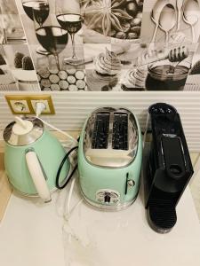 a toaster and a phone sitting on a shelf at GouldVilla Vendégház in Villány