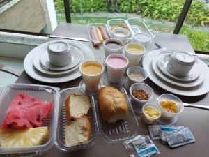 a table with a tray of sandwiches and cups of coffee at Iloa Prime 103 V in Barra de São Miguel