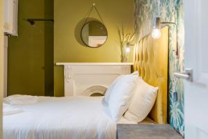 a bedroom with a bed with a fireplace and a mirror at Queen Street Apartments by Sasco in Blackpool