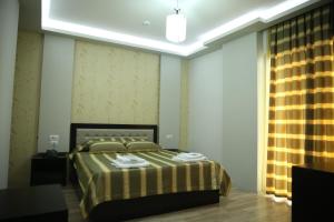 a bedroom with a bed and a lamp at Hotel Pogradeci in Pogradec