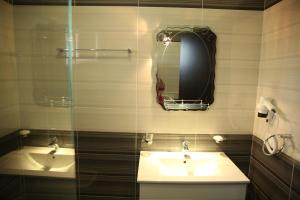 a bathroom with a sink and a mirror at Hotel Pogradeci in Pogradec