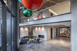 a lobby with a couch and a table and balloons at Cordis, Auckland by Langham Hospitality Group in Auckland