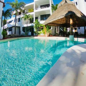 a swimming pool in front of a hotel at Marisol Beach in Playa del Carmen