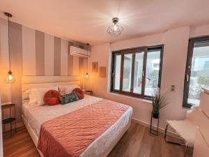a bedroom with a bed and a window at Stylish Voula Apartment with pool close to Kavouri Beach in Athens