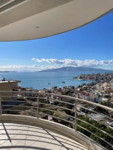 a view of the ocean from the balcony of a house at L.T. Apartment 5th street in Sarandë