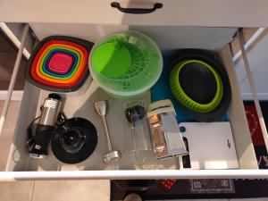 a drawer filled with dishes and other kitchen utensils at Petite maison alsacienne in Entzheim +29 photos