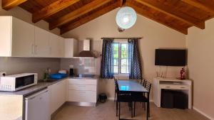 a small kitchen with a table and a microwave at Villa da Silva in Madalena