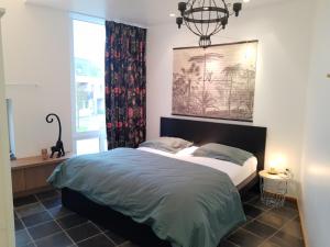 Tempat tidur dalam kamar di Vakantiewoning 'De Vlaamse Aap'