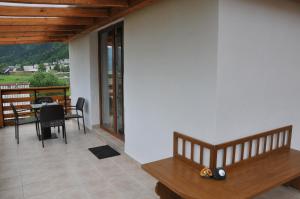 a living room with a table and a balcony at Apartment Tina in Bohinj