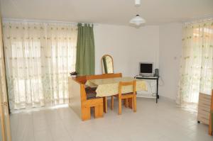 a dining room with a table and chairs and a desk at Apartment Tina in Bohinj