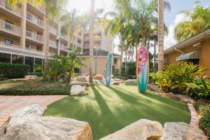two surfboards on a lawn in front of a building at Holiday Inn Club Vacations Cape Canaveral Beach Resort, an IHG Hotel in Cape Canaveral
