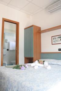 Postel nebo postele na pokoji v ubytování Hotel Trifoglio
