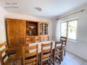 ein Esszimmer mit einem Tisch, Stühlen und einem Fenster in der Unterkunft Vacation Rentals Croatia in Split