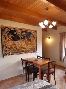 a dining room with a wooden table and chairs at Agroturystyka Tam Gdzie Sosny in Ścinawka Dolna