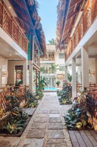 an empty courtyard of a building with plants at MUNI MUNI VILLAS SIARGAO in General Luna