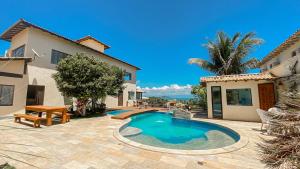 a house with a swimming pool in a yard at Fantasy Buzios in Búzios