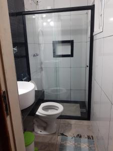 a bathroom with a toilet and a sink at Pousada Uai Tiradentes in Tiradentes