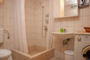 a bathroom with a shower and a toilet and a sink at Apartment Sve - with parking in Makarska