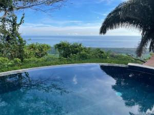 a swimming pool with a view of the ocean at Finca Cuipo in Buritaca