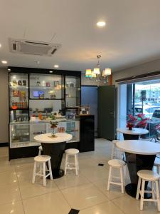 a restaurant with two tables and two stools at K VILA HOTEL in Sungai Petani