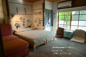 una camera da letto con un letto, una sedia e una finestra di Here Sleep Guesthouse a Kaohsiung