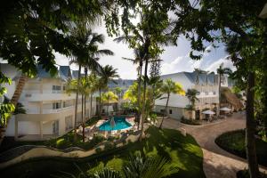 an aerial view of the resort with a swimming pool and palm trees at Casa Marina Beach & Reef All Inclusive in Sosúa