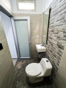 a bathroom with a toilet and a sink at Sagrado Hotel in Aguachica