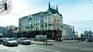 a large building on a busy city street with cars at AMN Center Apartment in Belgrade