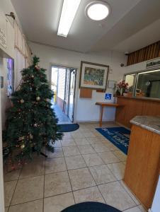 a christmas tree in a waiting room with a christmas at Americas Best Value Inn Oxnard-Port Hueneme in Port Hueneme