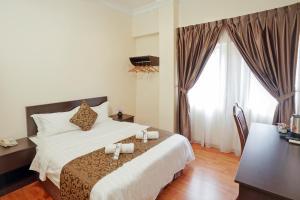 Postel nebo postele na pokoji v ubytování RJ Hotel Kulai