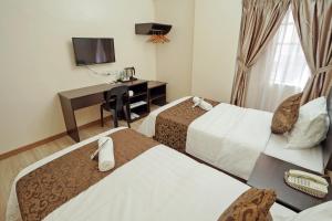 Postel nebo postele na pokoji v ubytování RJ Hotel Kulai